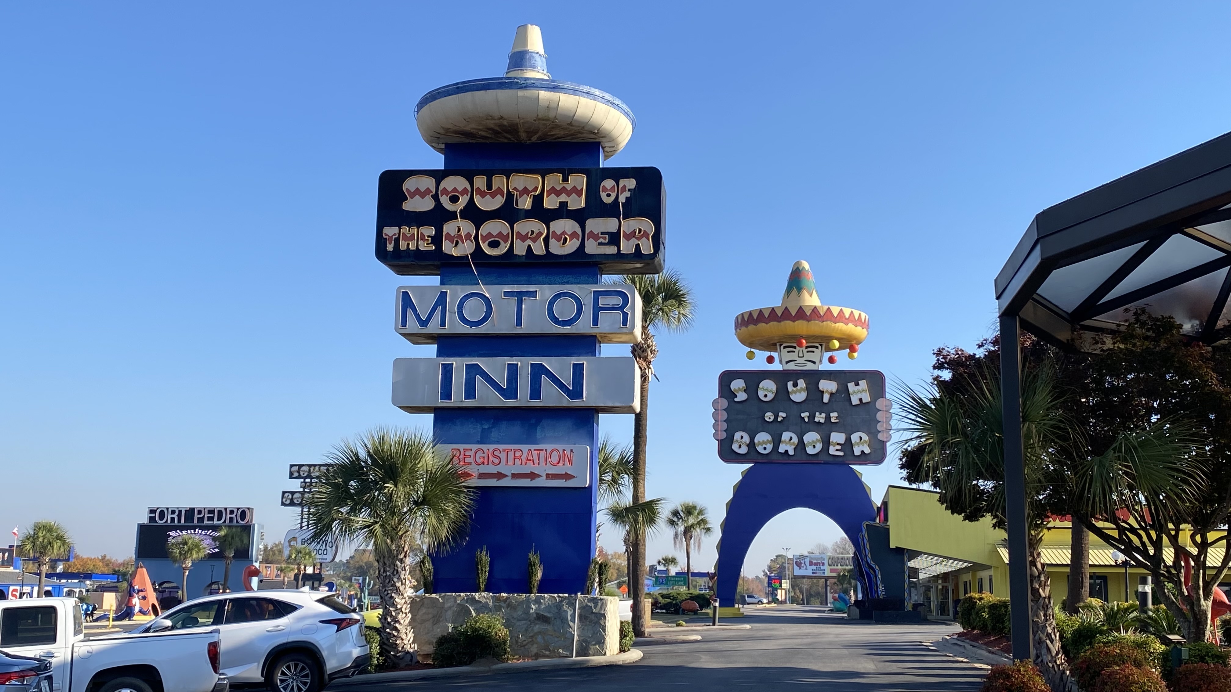 a sign with a sombrero and a sign on the side of the road