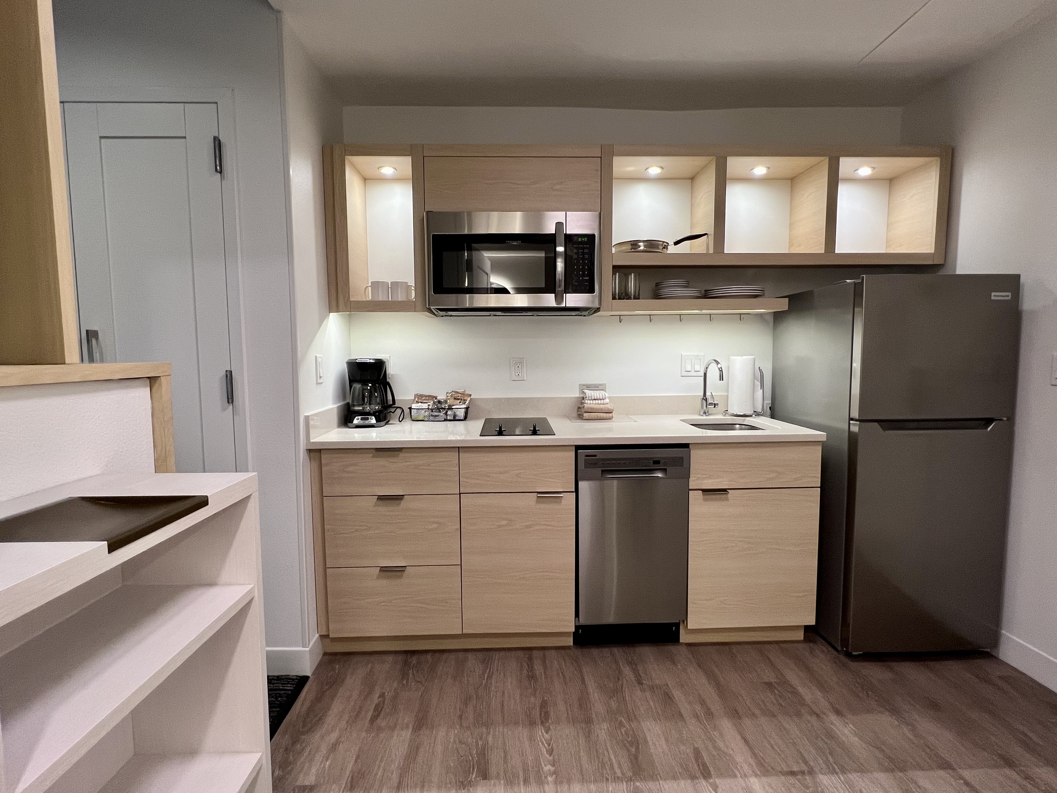 a kitchen with a stainless steel refrigerator and microwave