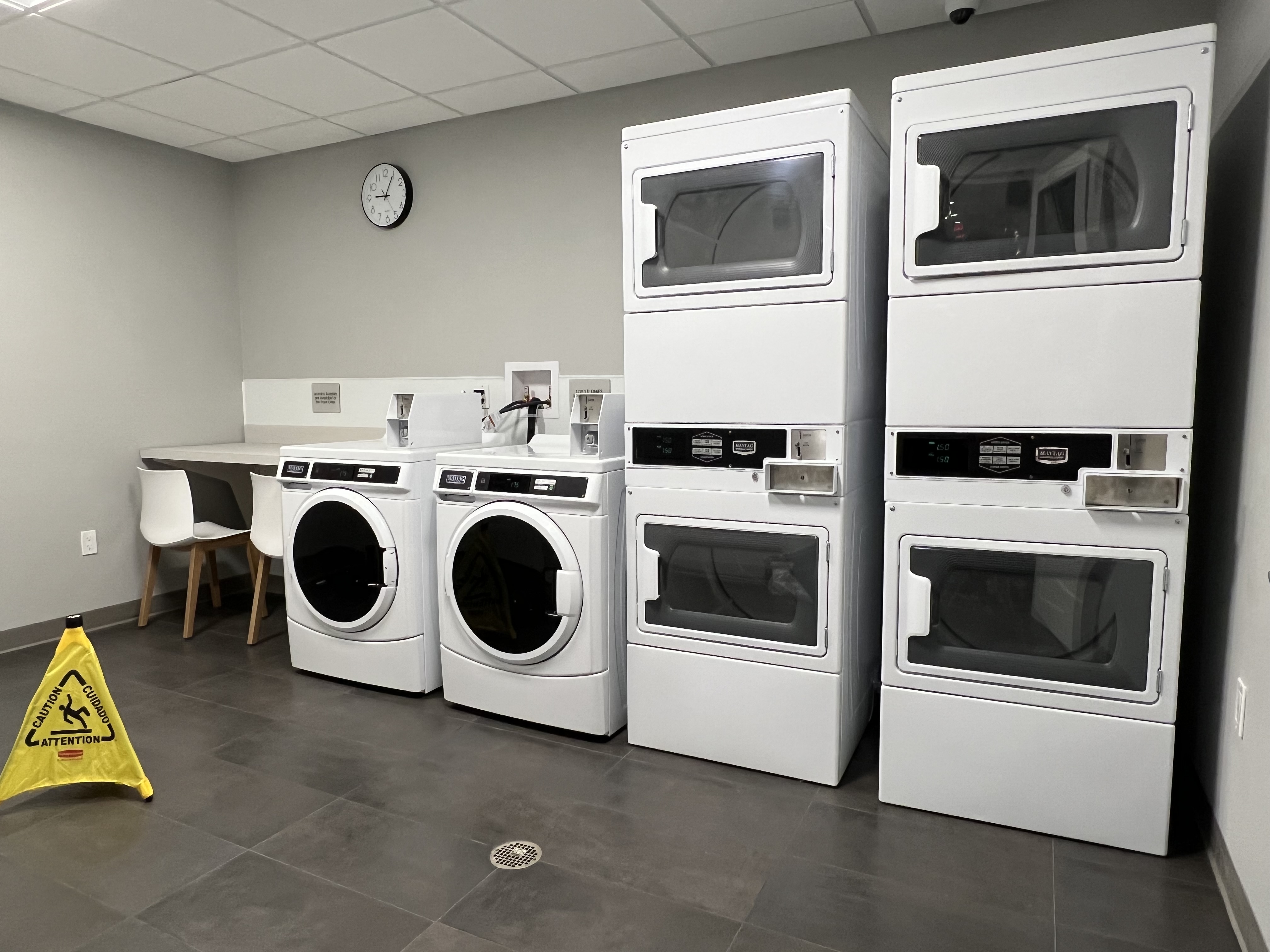 a group of white washing machines in a room