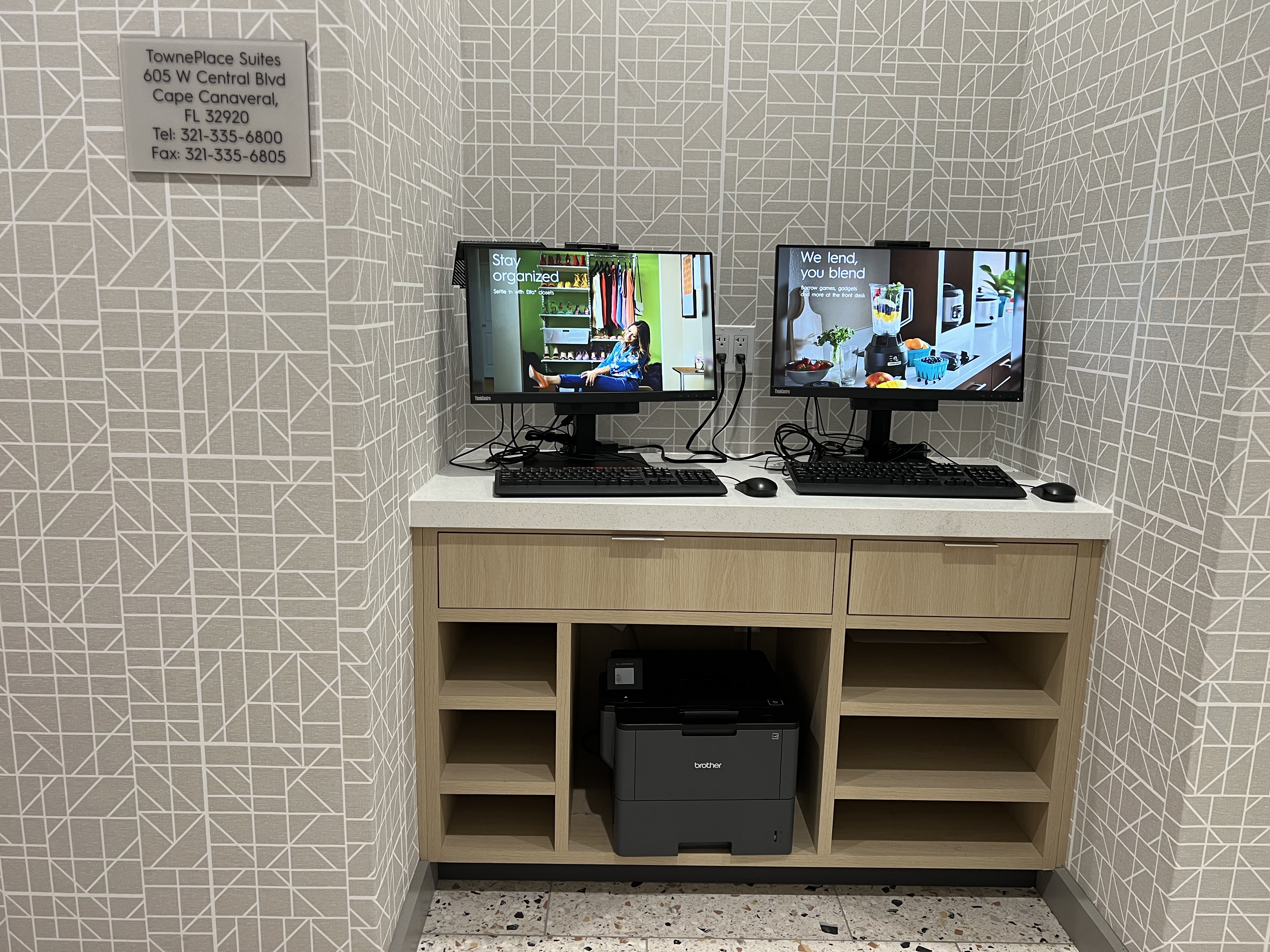 a computer desk with two monitors