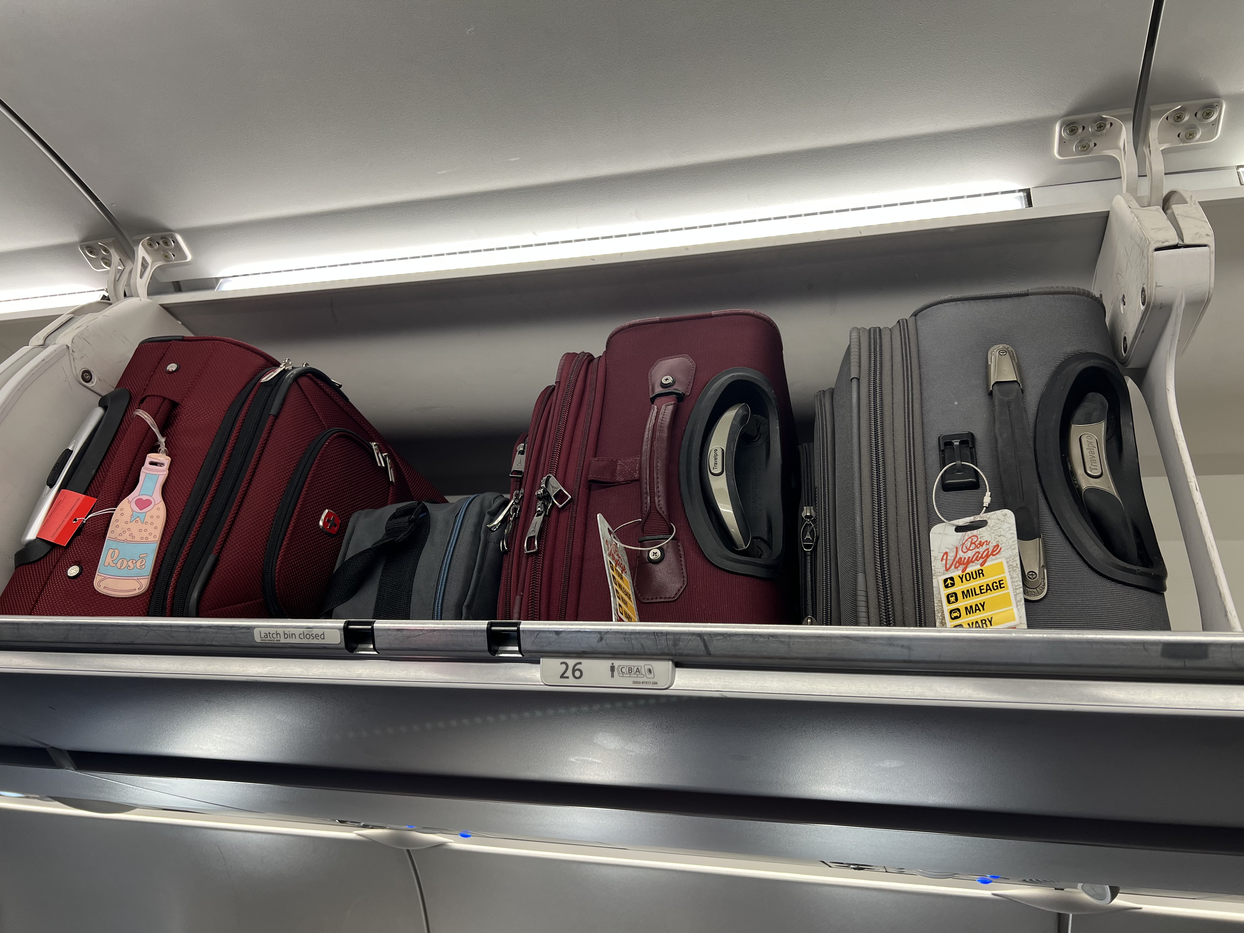 a group of luggage on a shelf