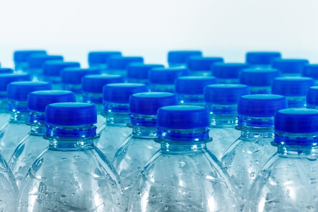 a group of empty bottles with blue caps