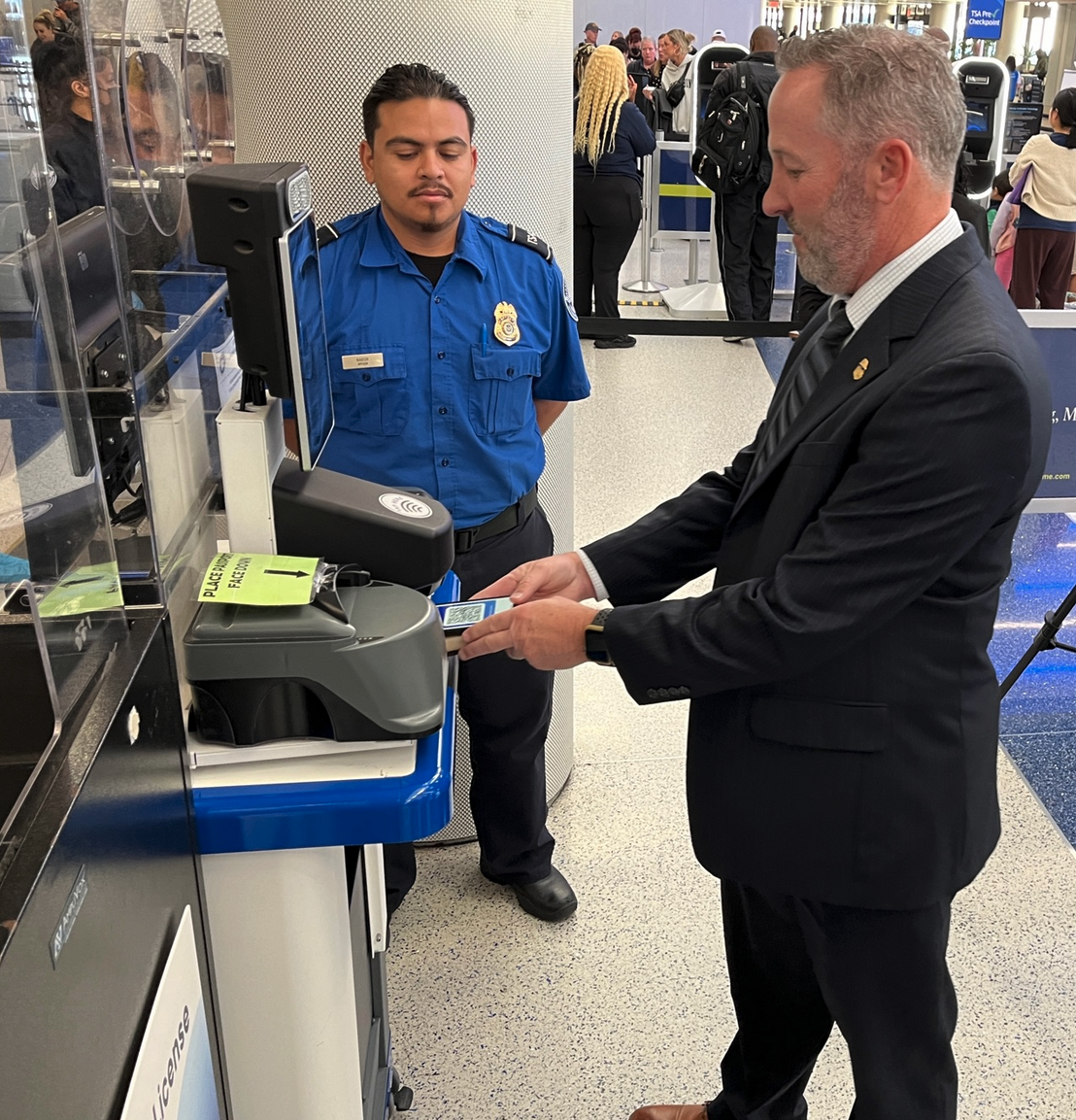 a man in a suit using a credit card to pay for a check in machine