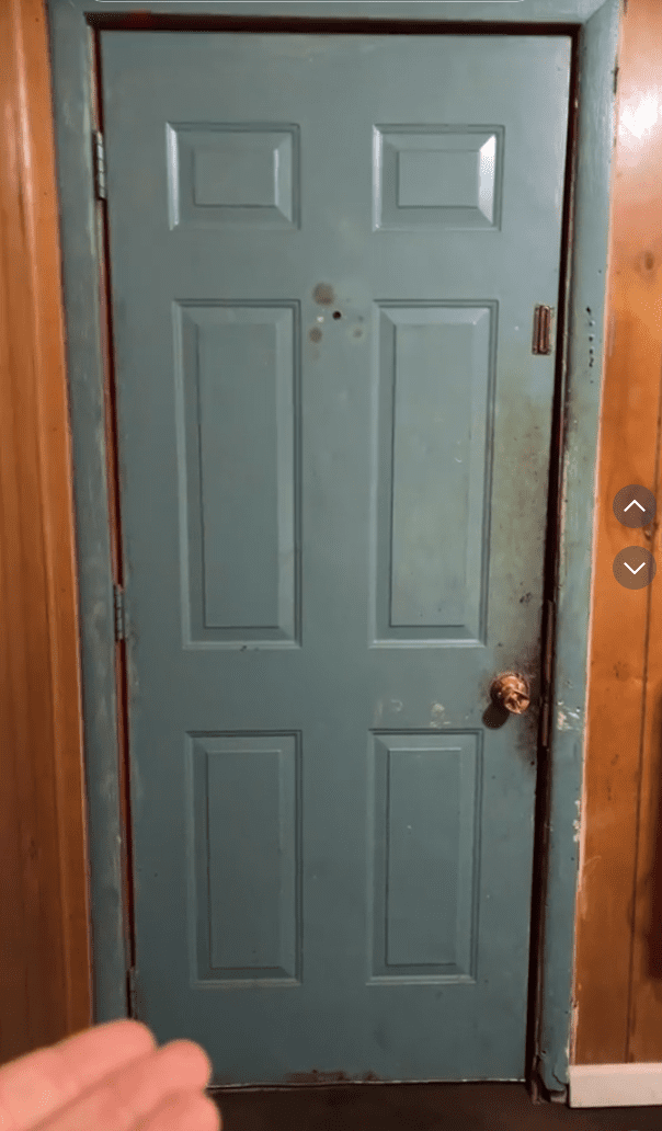 a blue door with a gold knob