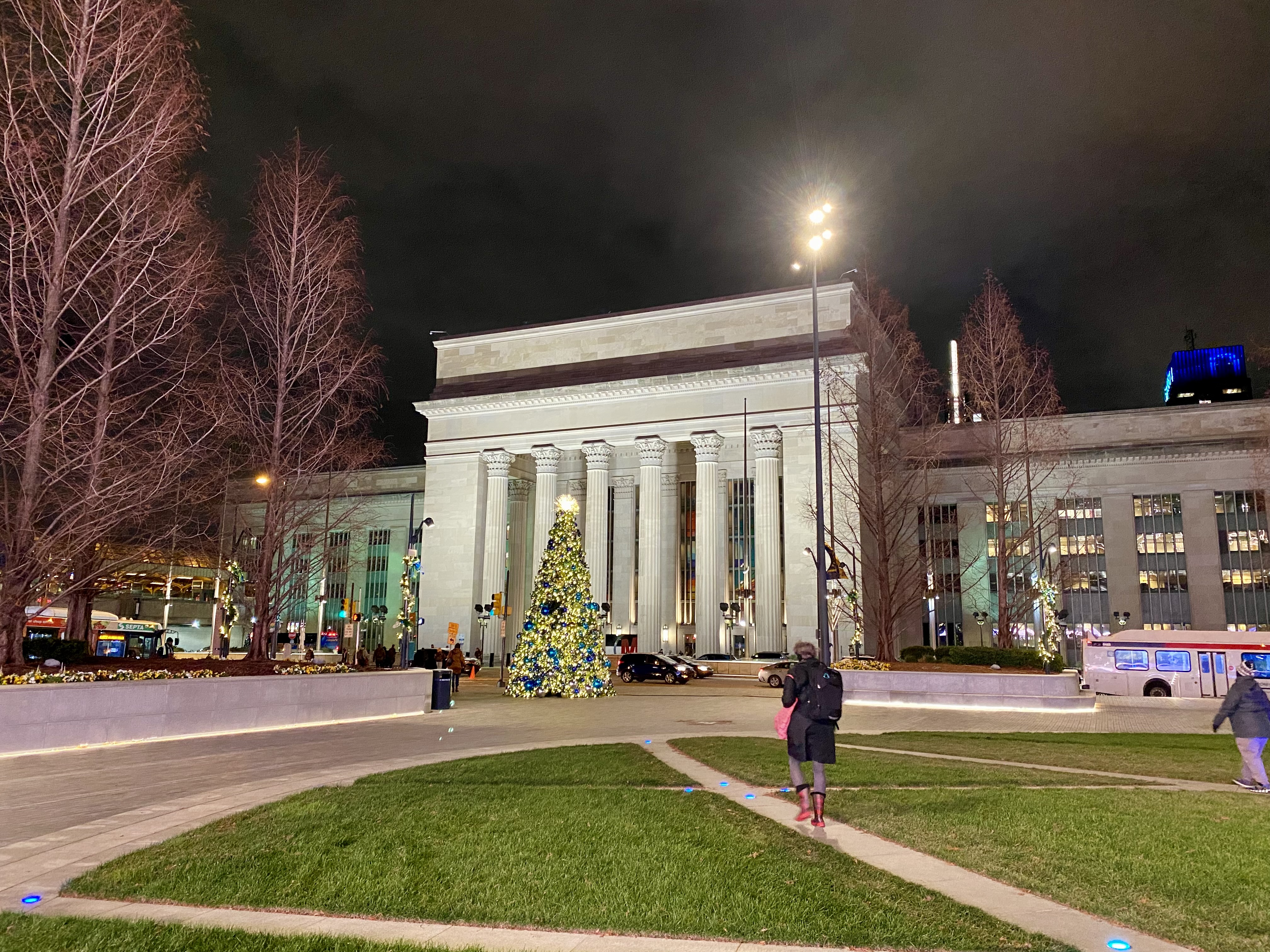 a building with columns and a christmas tree