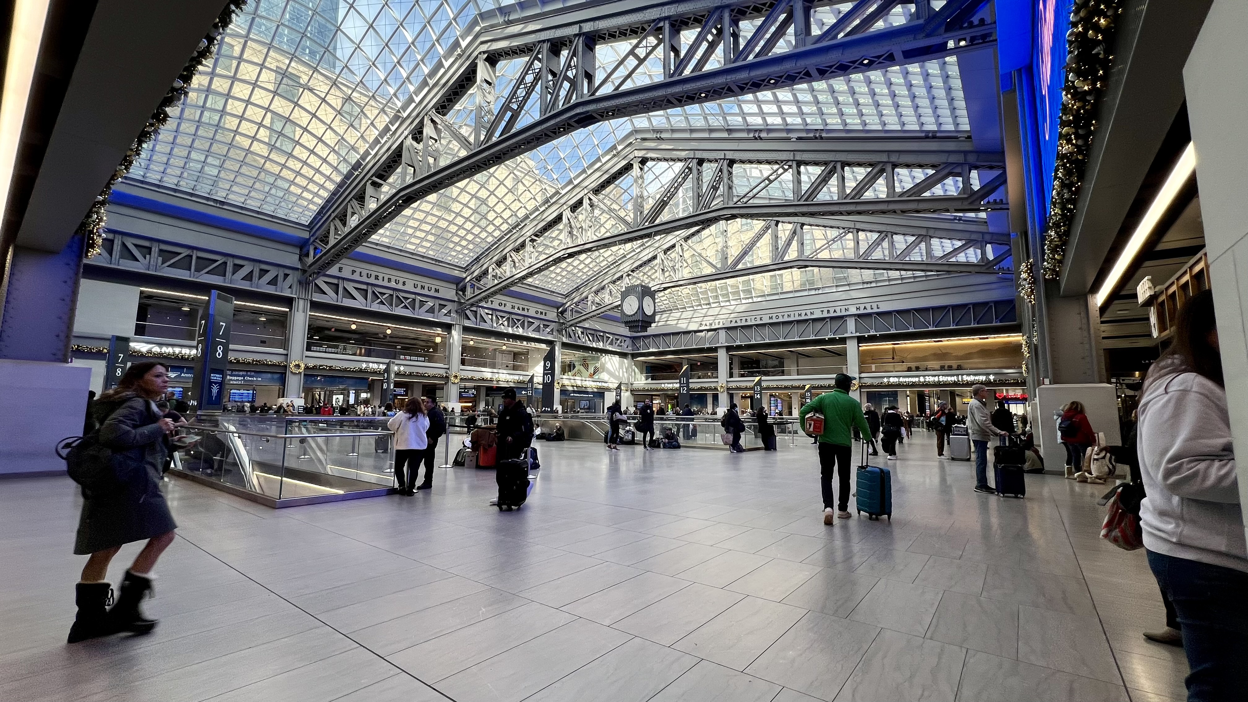 a large glass ceiling with people walking in it