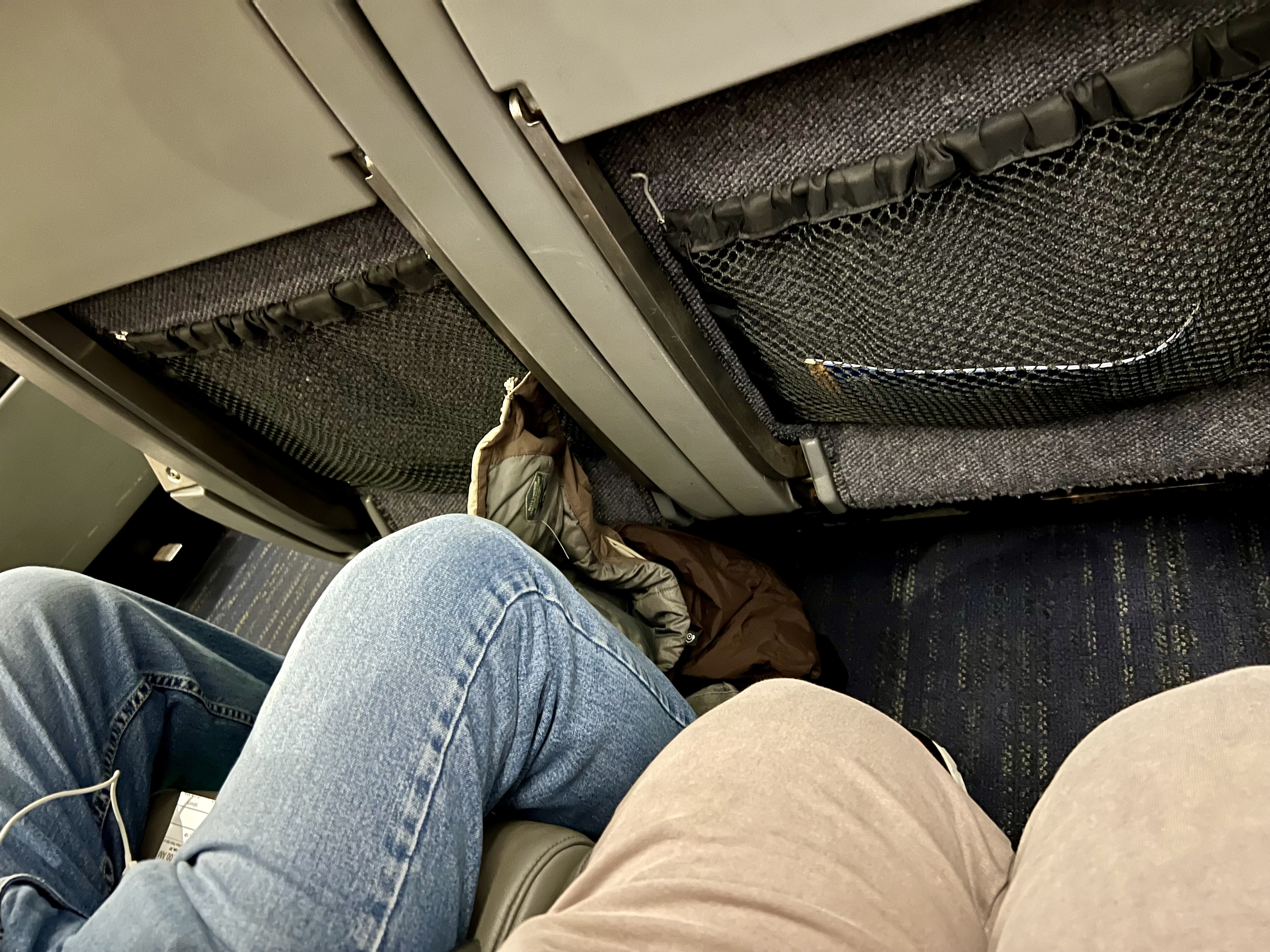 a person's legs and feet on a plane