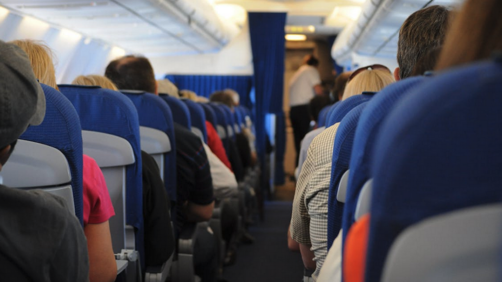 a group of people sitting in an airplane