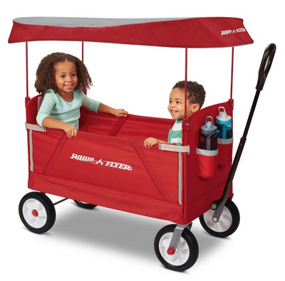 a couple of children in a red wagon