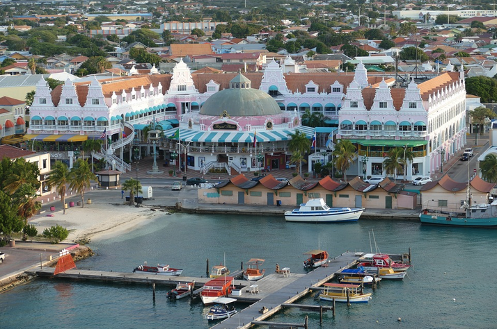 a large building with a dome and a pier with boats in it