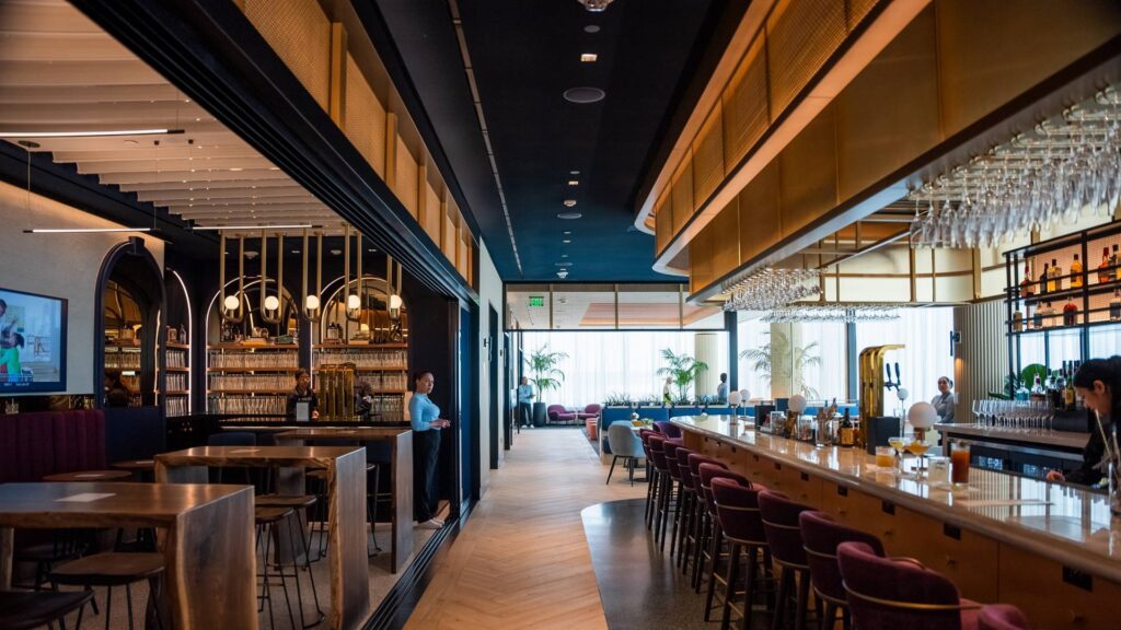 a bar with chairs and tables in a restaurant