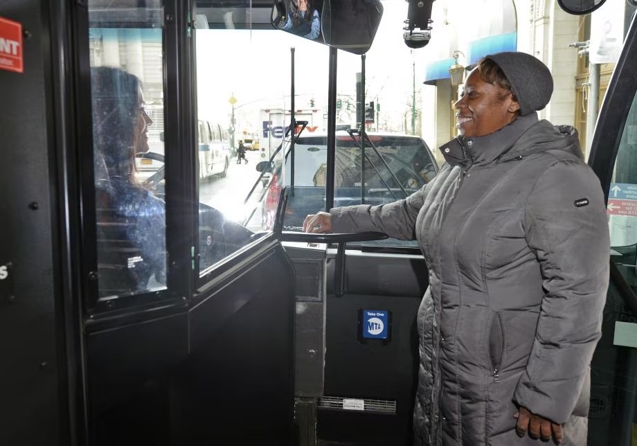 a woman standing in a bus