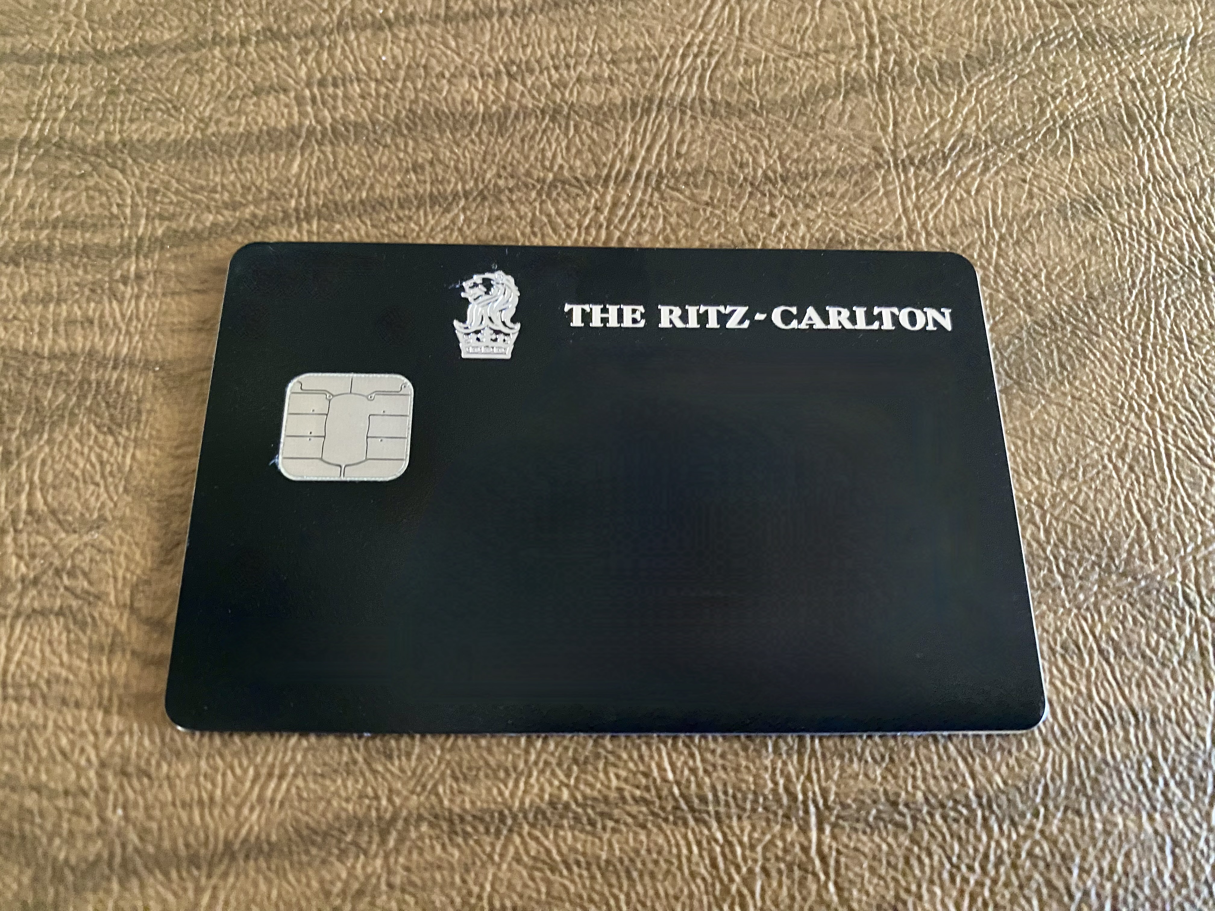 a black credit card on a brown surface