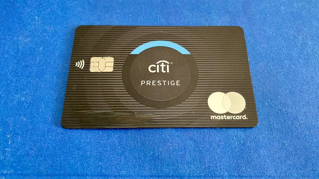 a black credit card on a blue surface