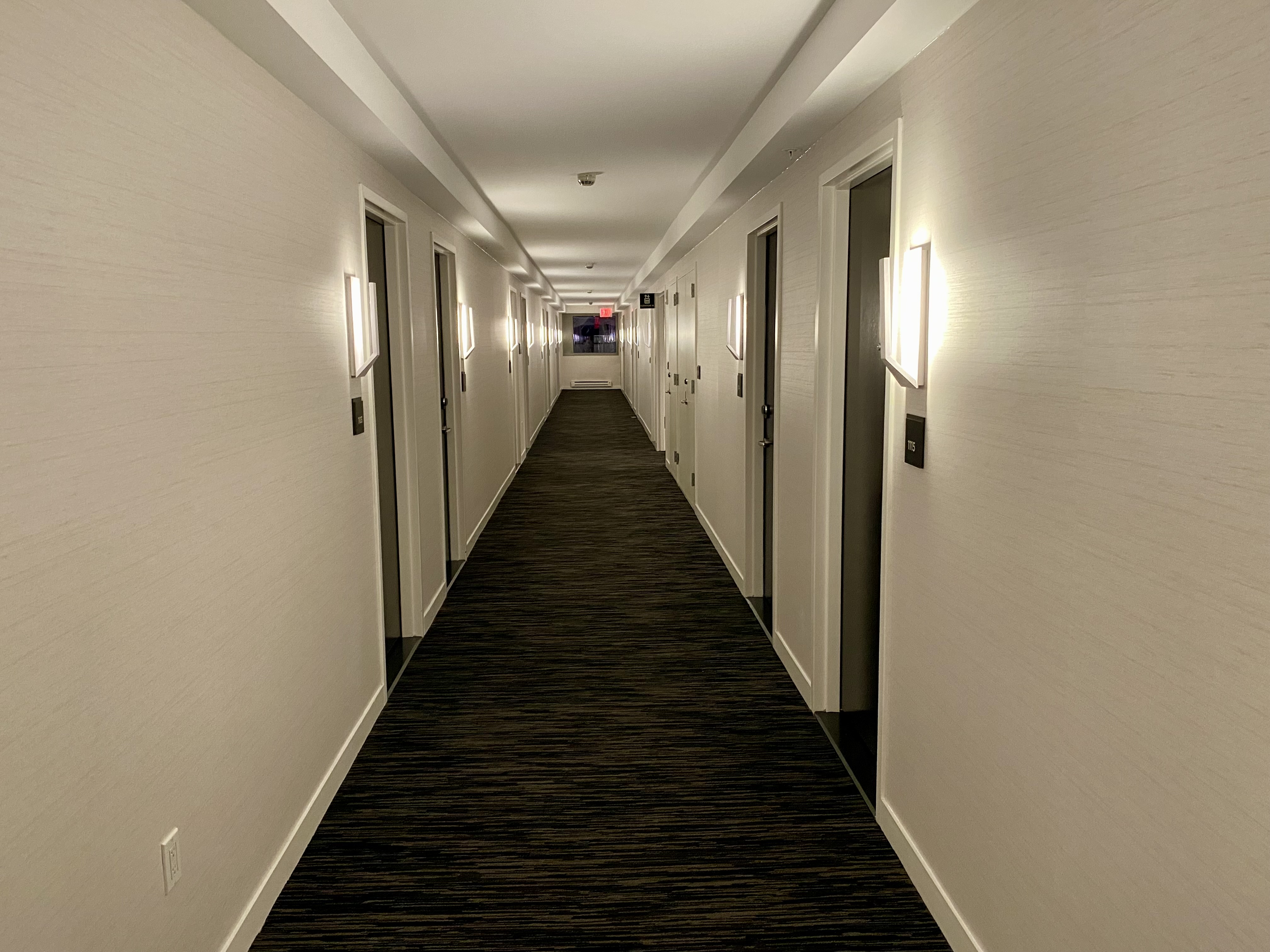 a hallway with doors and lights