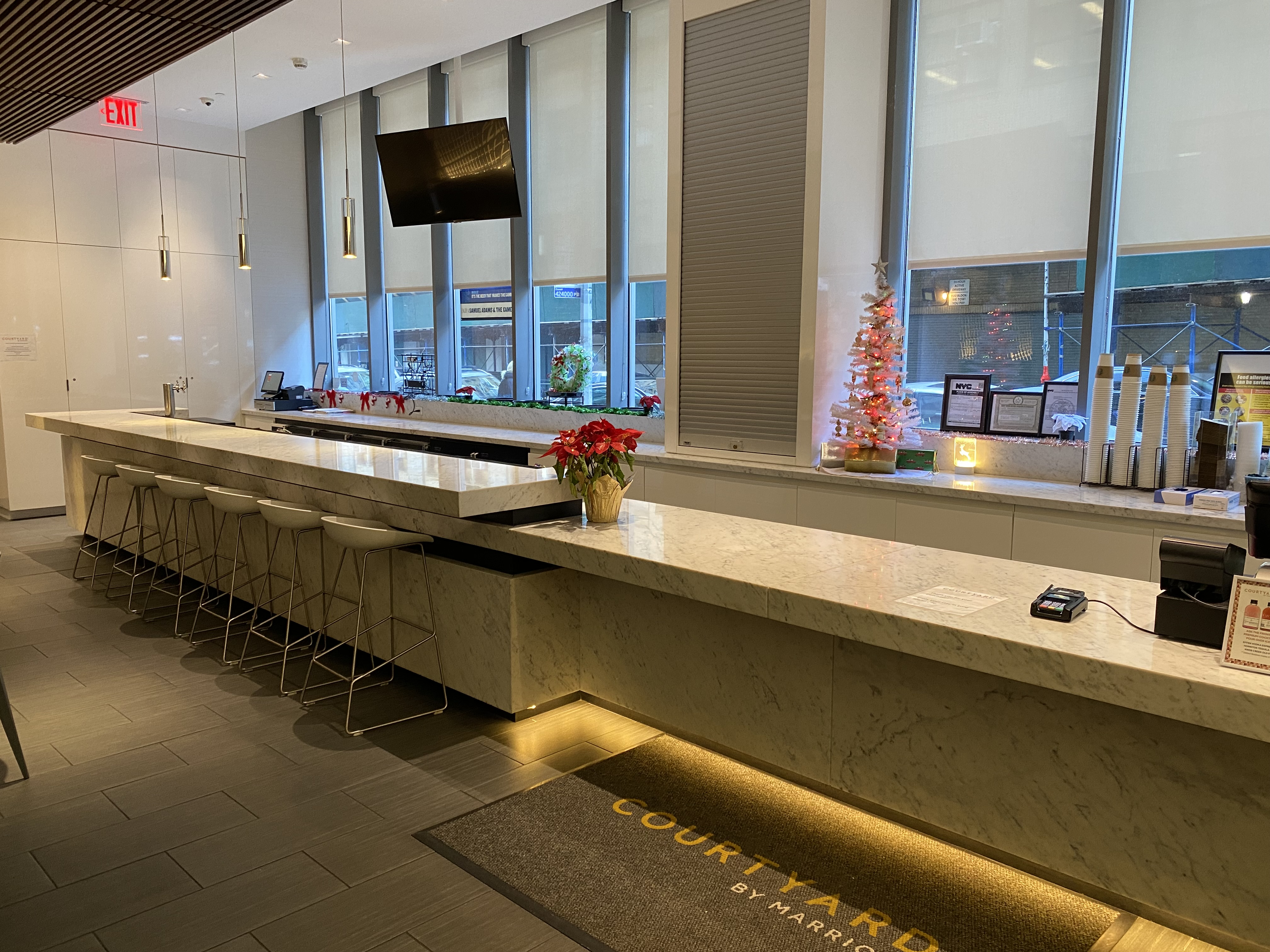 a room with a bar counter and a tv