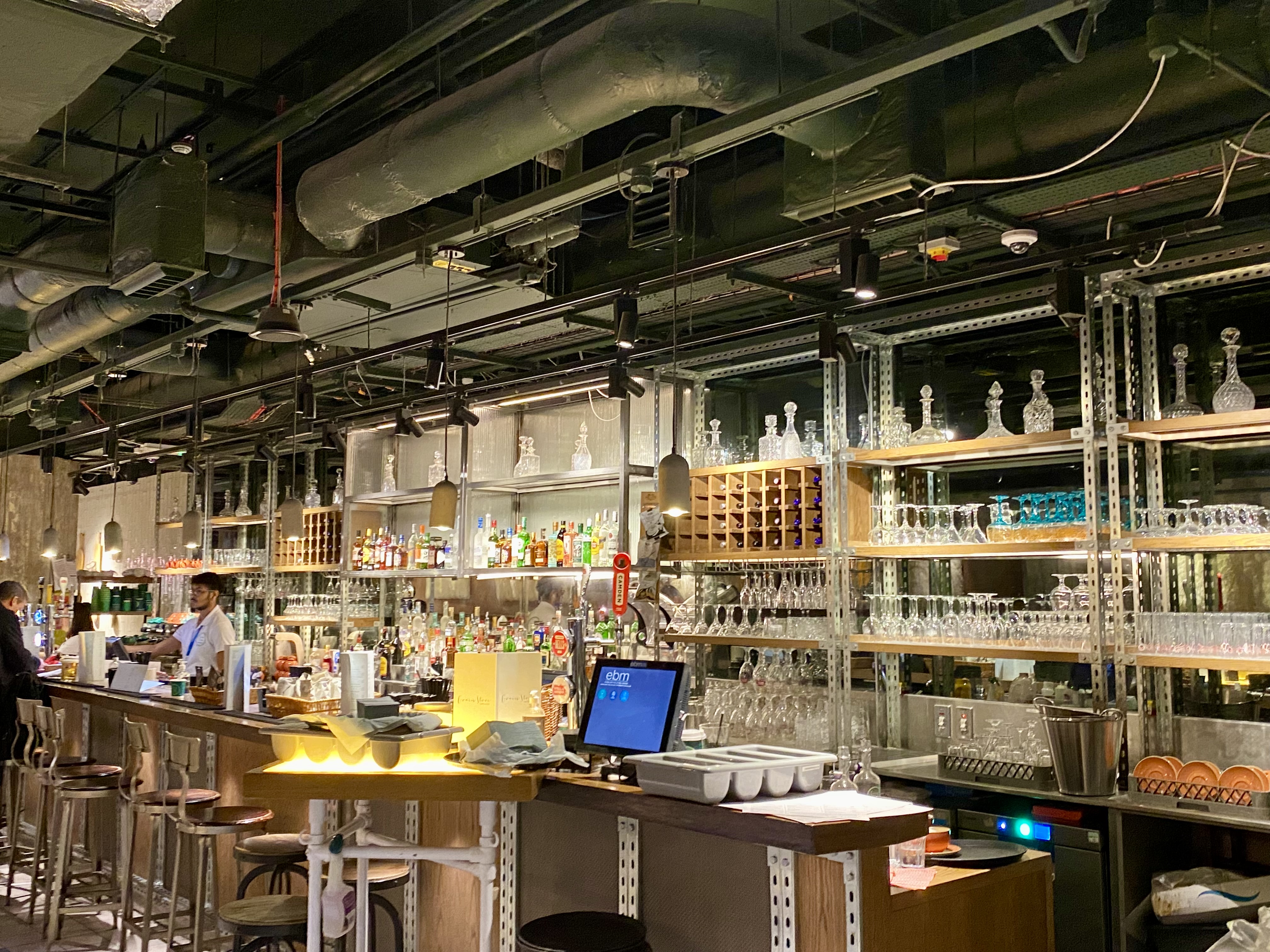 a bar with many glasses and bottles