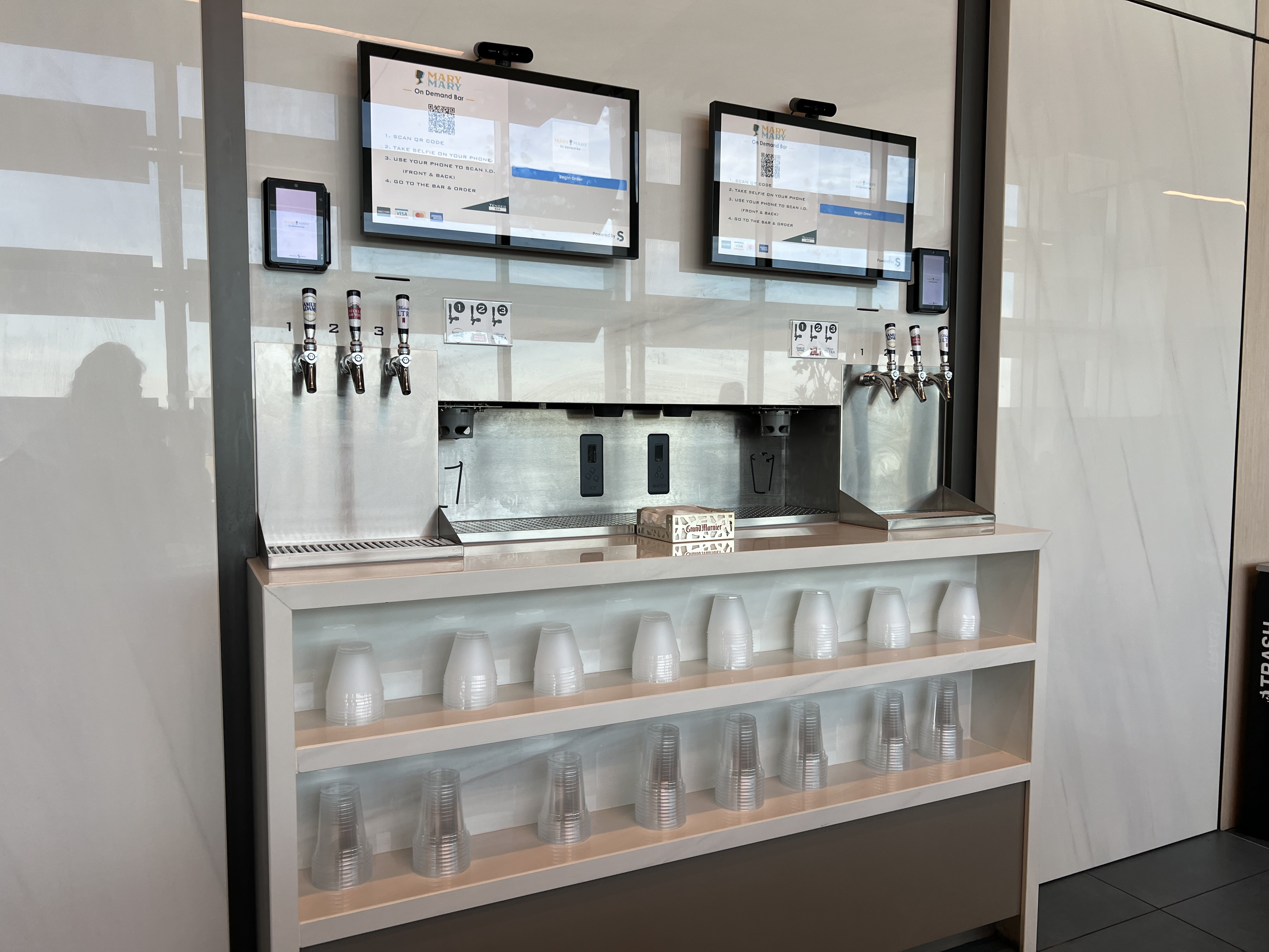 a beverage dispenser and a dispenser on a wall