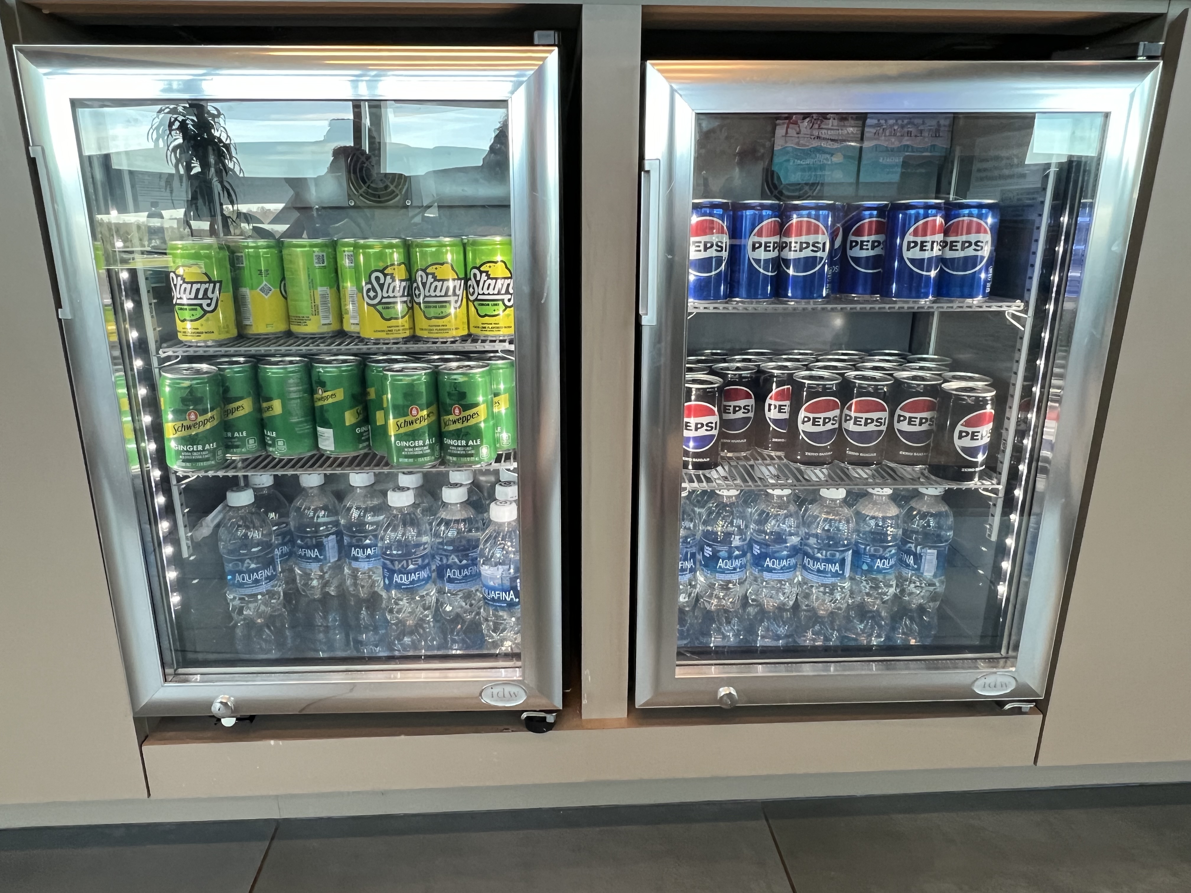 a refrigerator with cans and bottles of soda