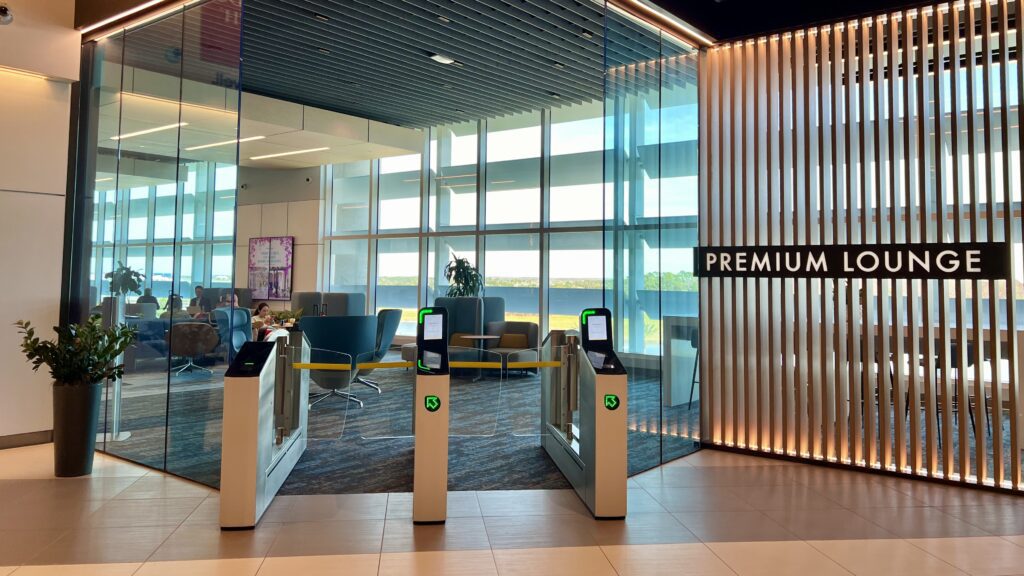 a entrance to a building with a glass wall and a sign