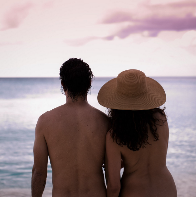 a man and woman standing on a beach