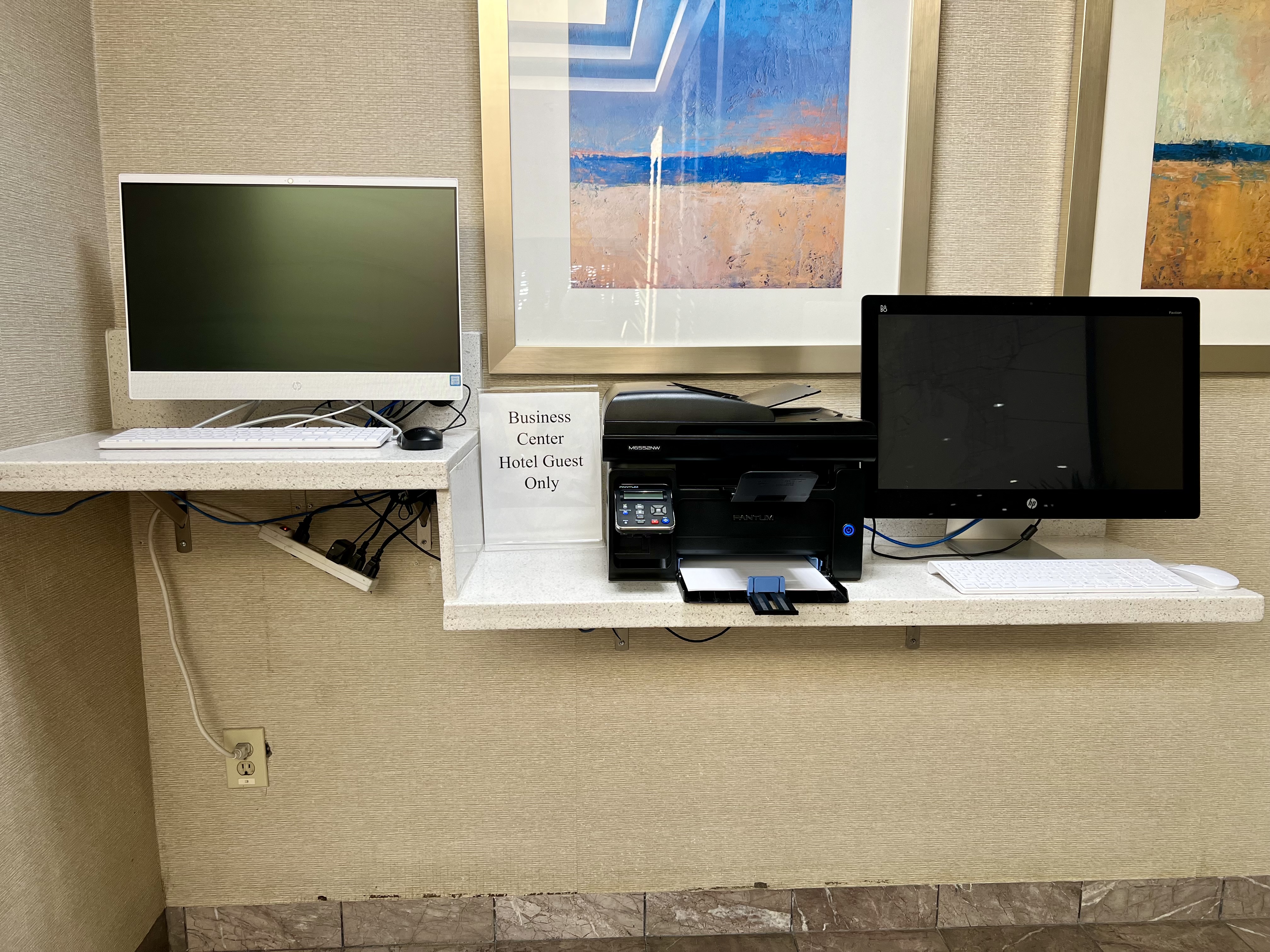 a computer and printer on a counter
