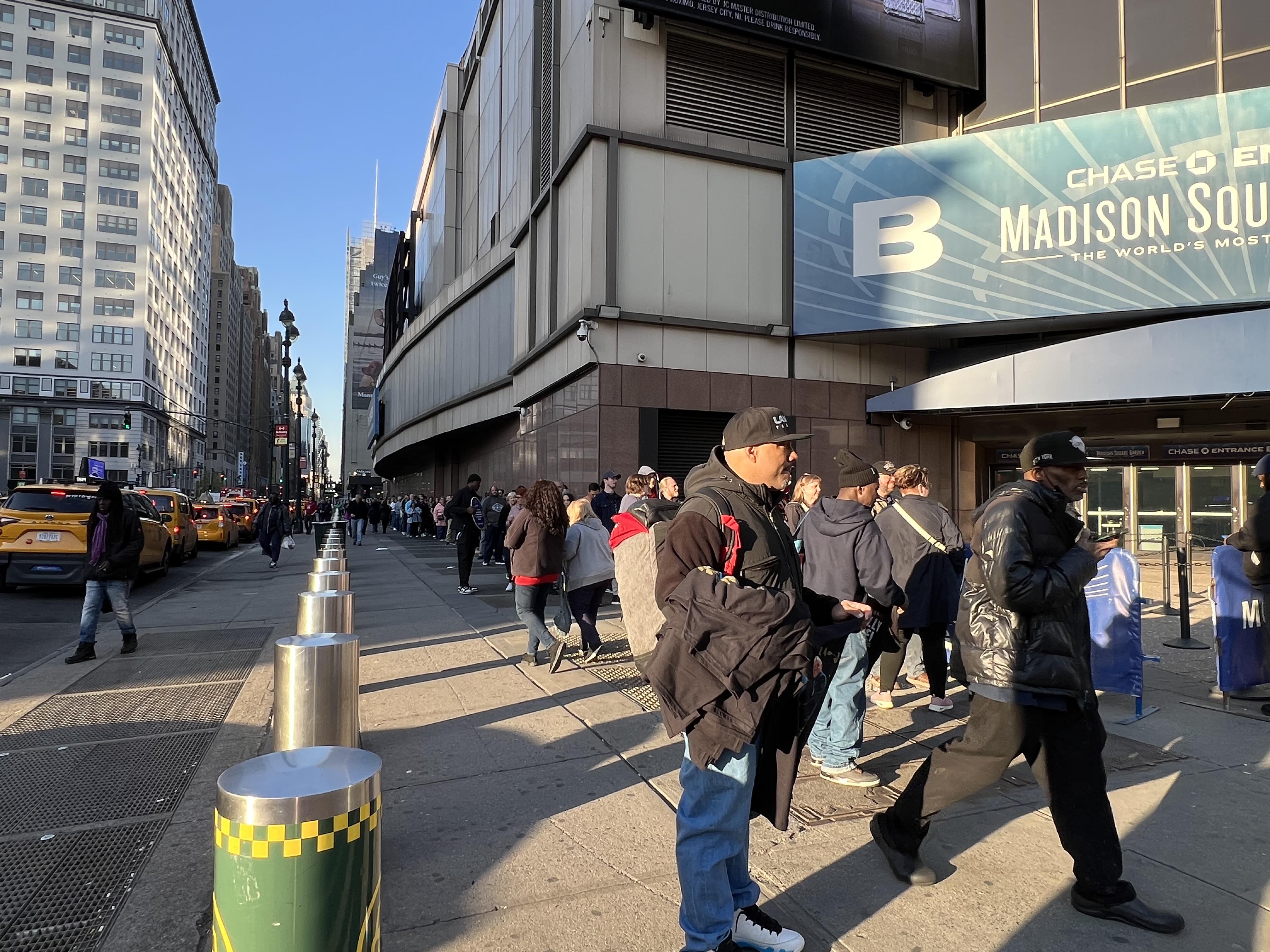 a group of people walking on a sidewalk