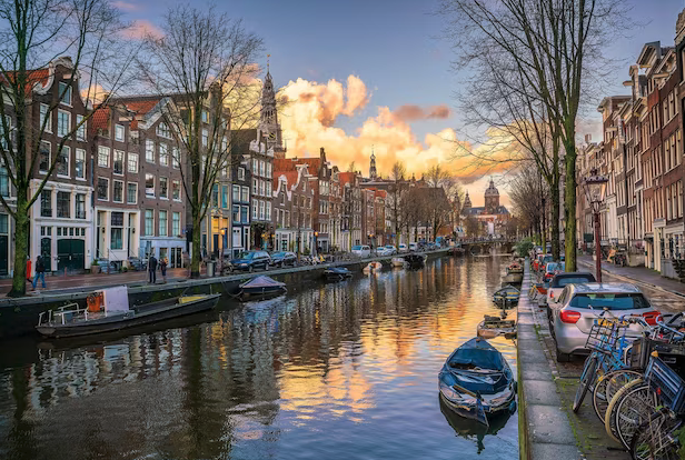 a canal with boats and buildings in the background