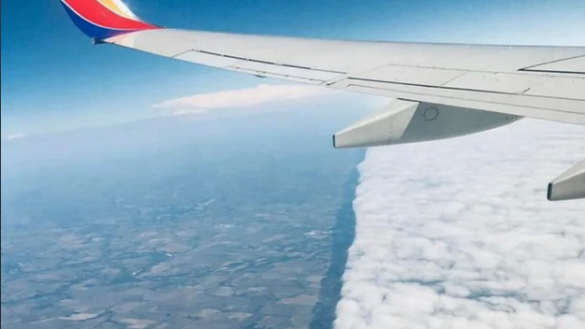 an airplane wing above clouds