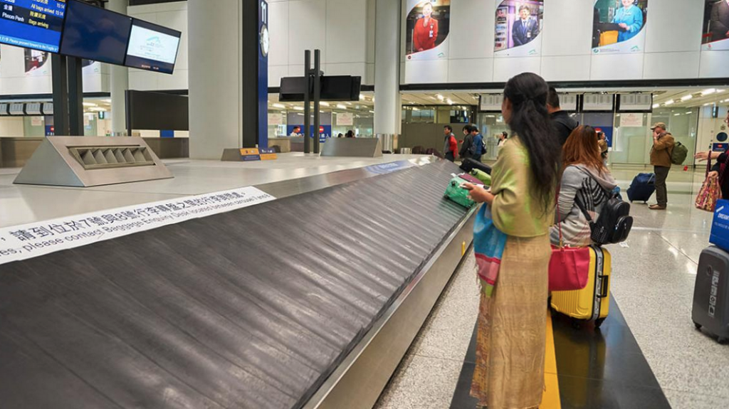 a woman standing at a conveyor belt