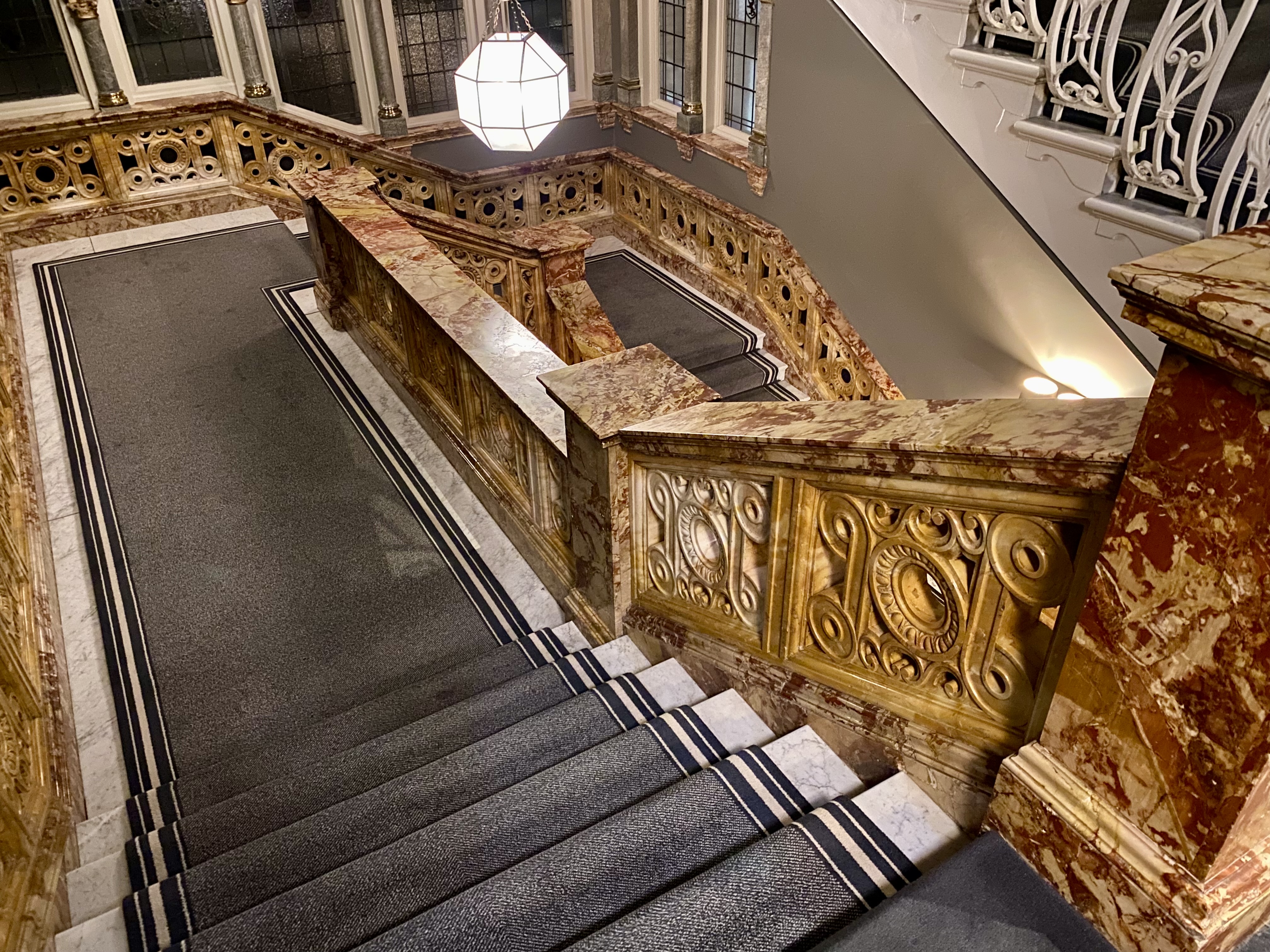 a staircase with a marble railing