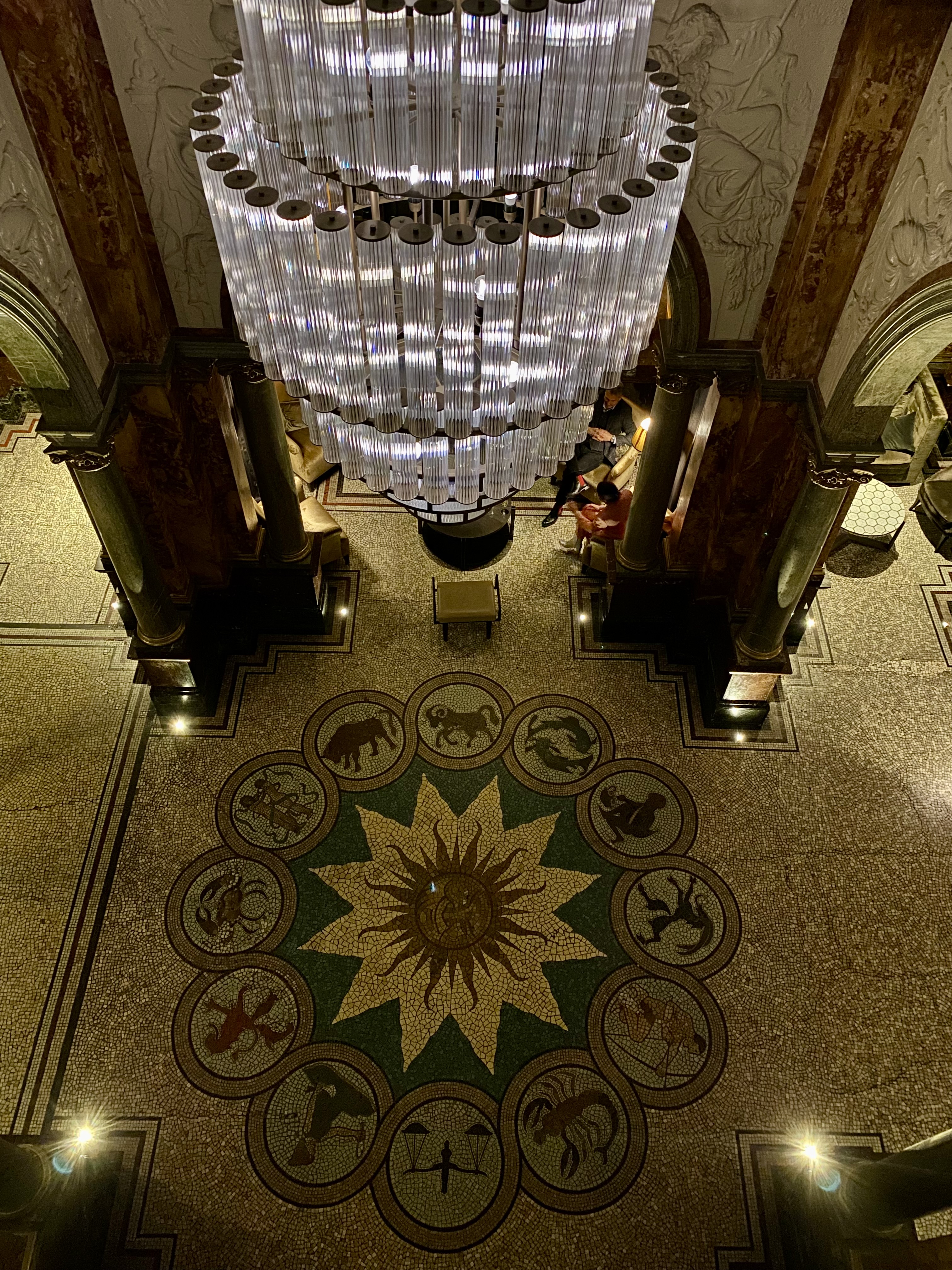 a chandelier in a room with a patterned floor