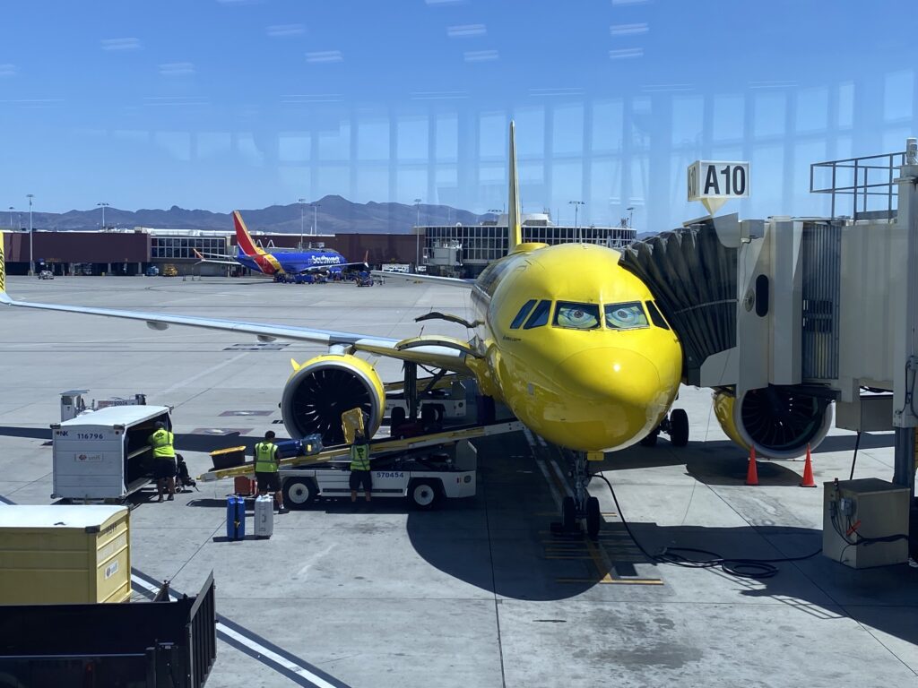 a yellow airplane at an airport