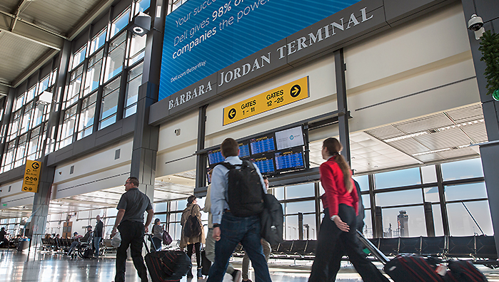 a group of people walking in an airport