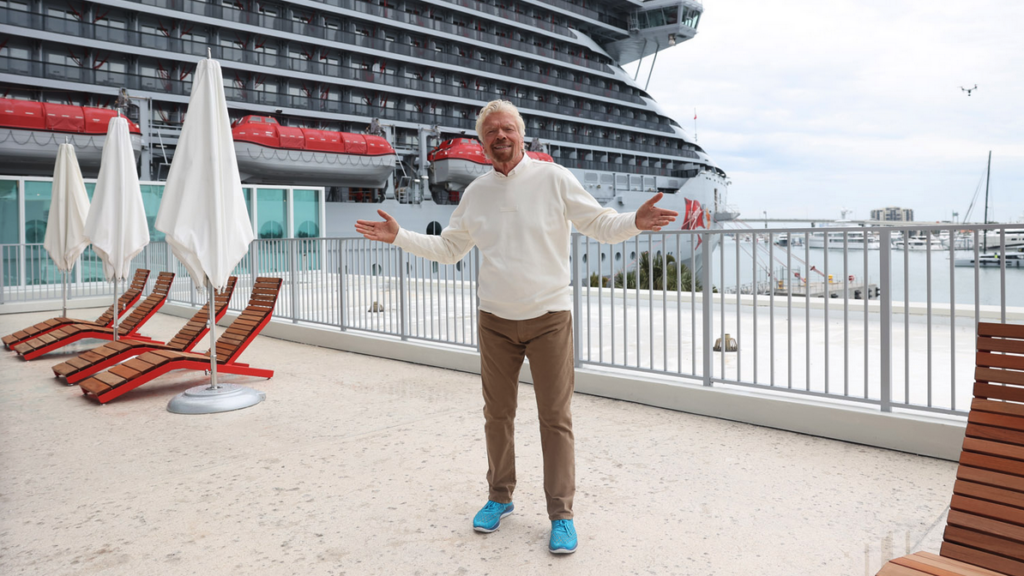 a man standing in front of a cruise ship