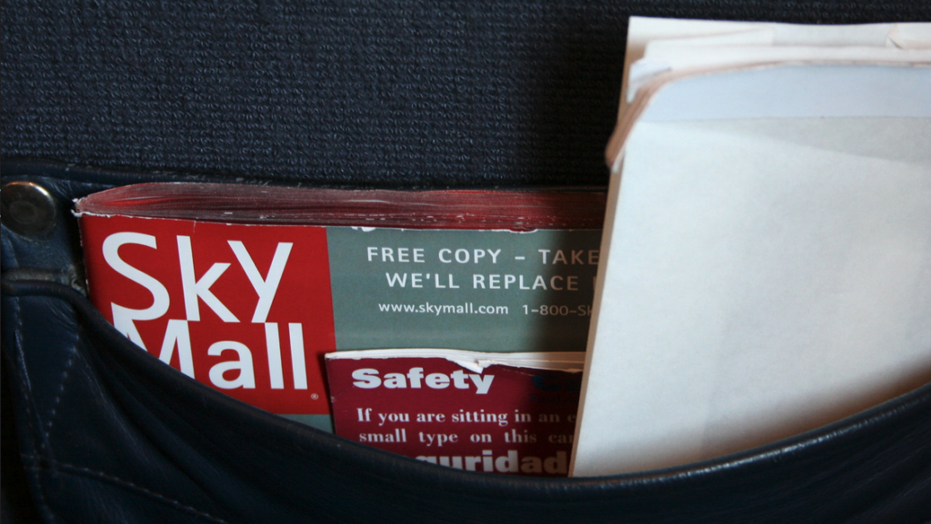 a pocket with a few magazines and a white envelope