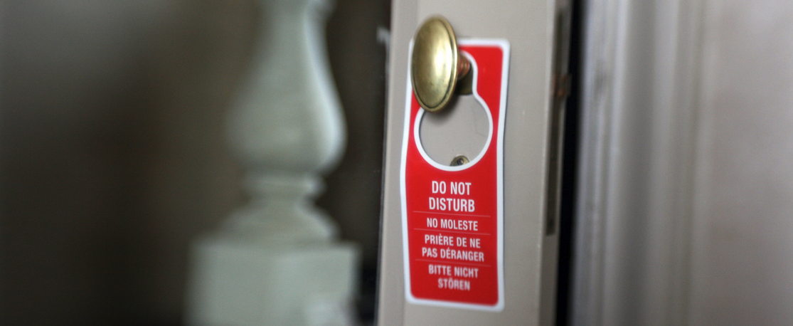 a red sign on a door handle