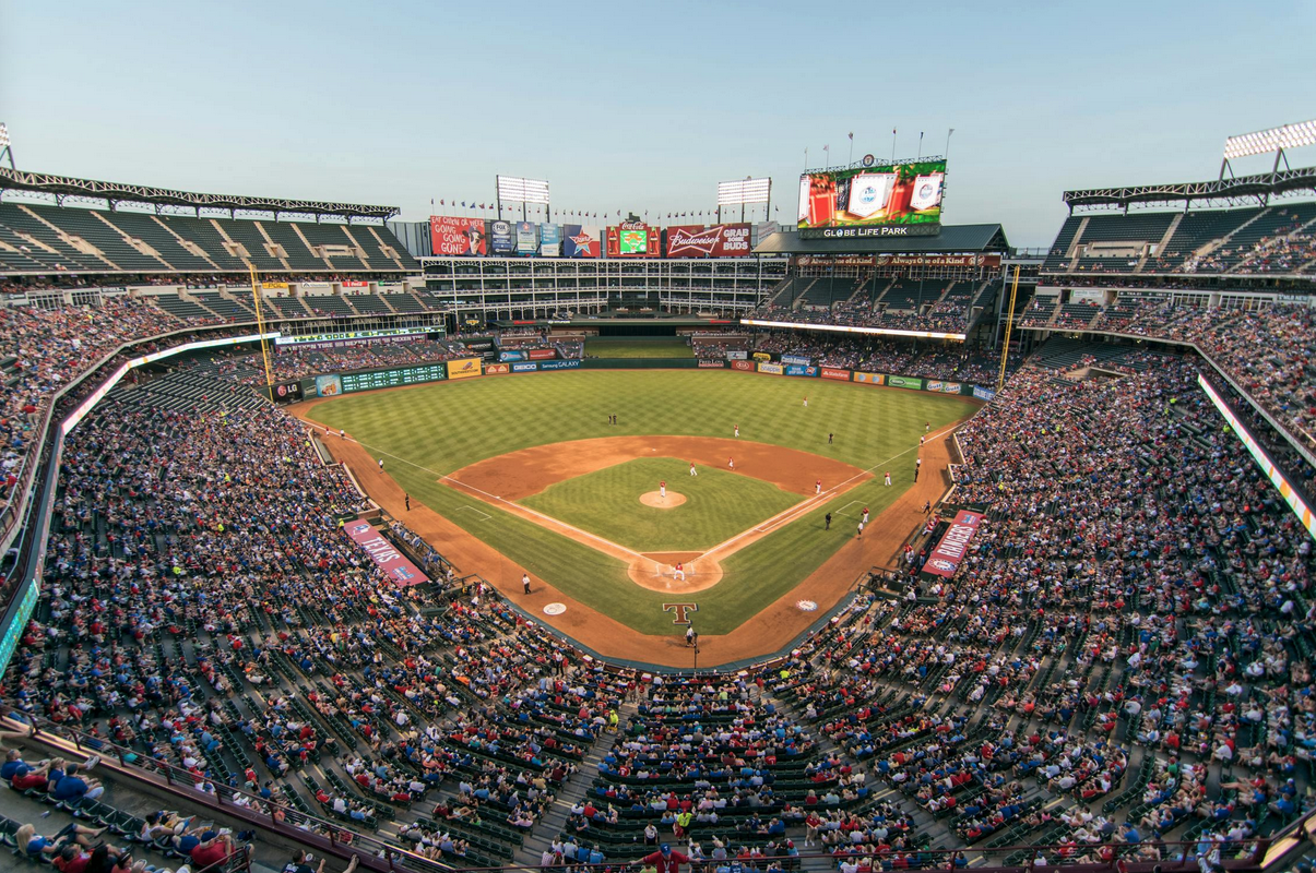 a baseball stadium with people in the stands with Globe Life Park in Arlington in the background