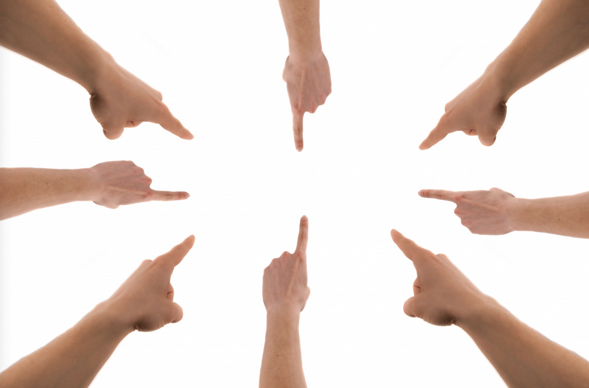 a group of hands pointing at each other