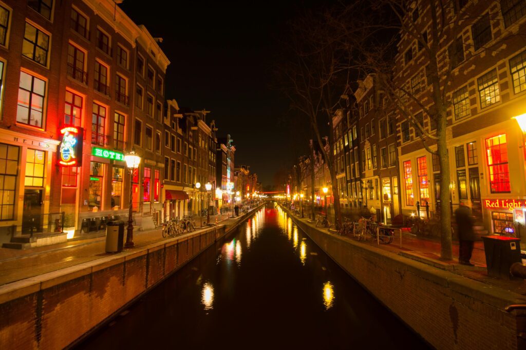 a canal with buildings and lights at night