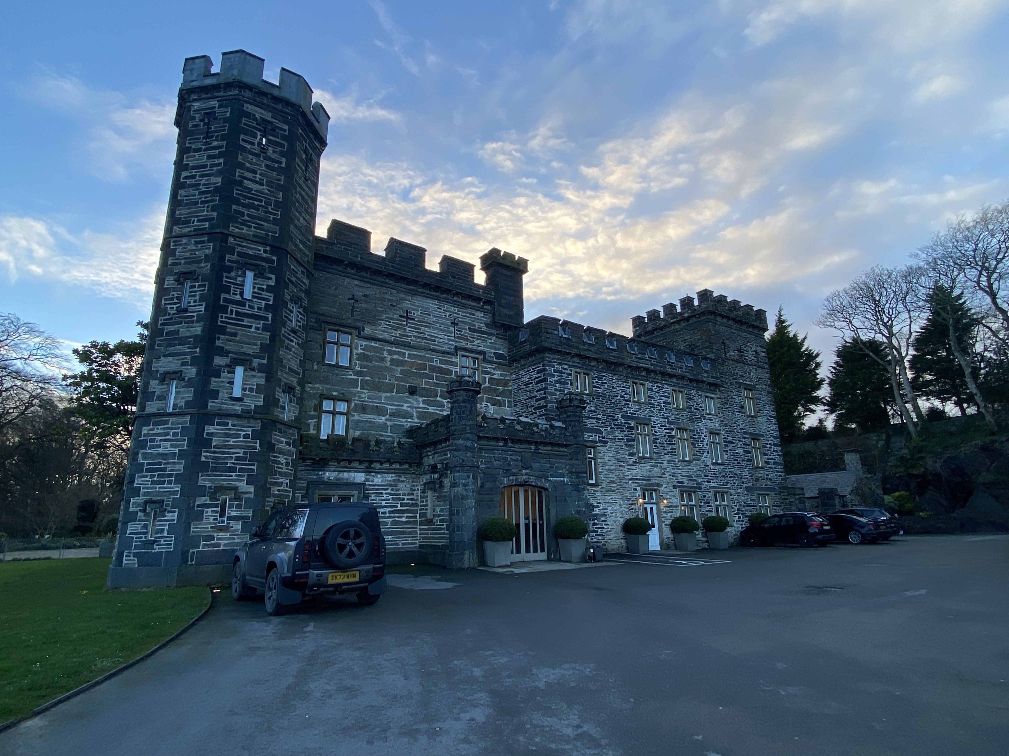 a stone castle with a car parked in front of it