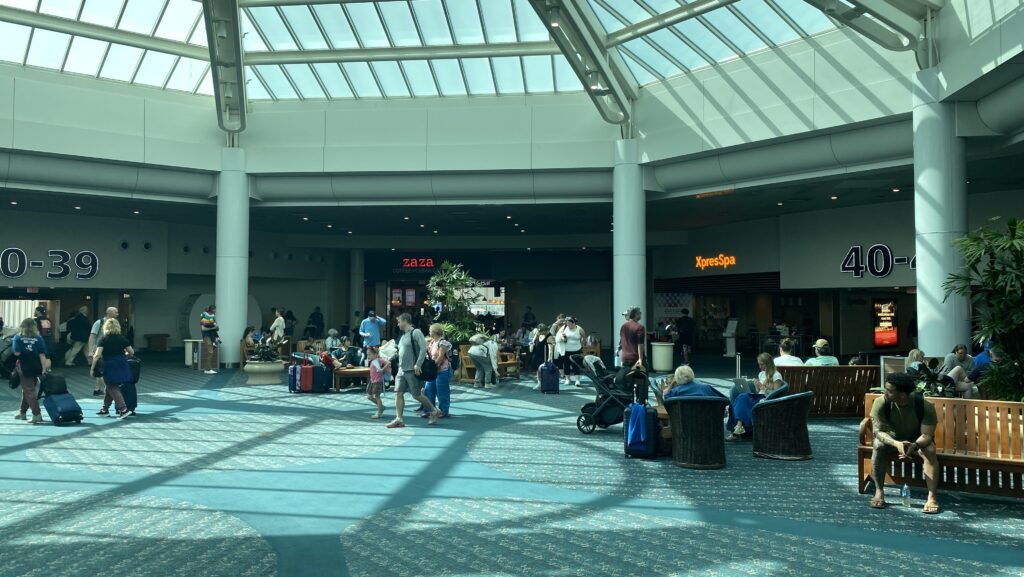 a group of people in a large airport terminal