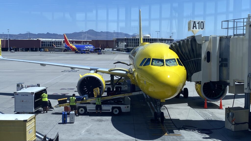 a yellow airplane at an airport