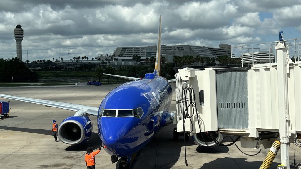 a blue airplane on a runway