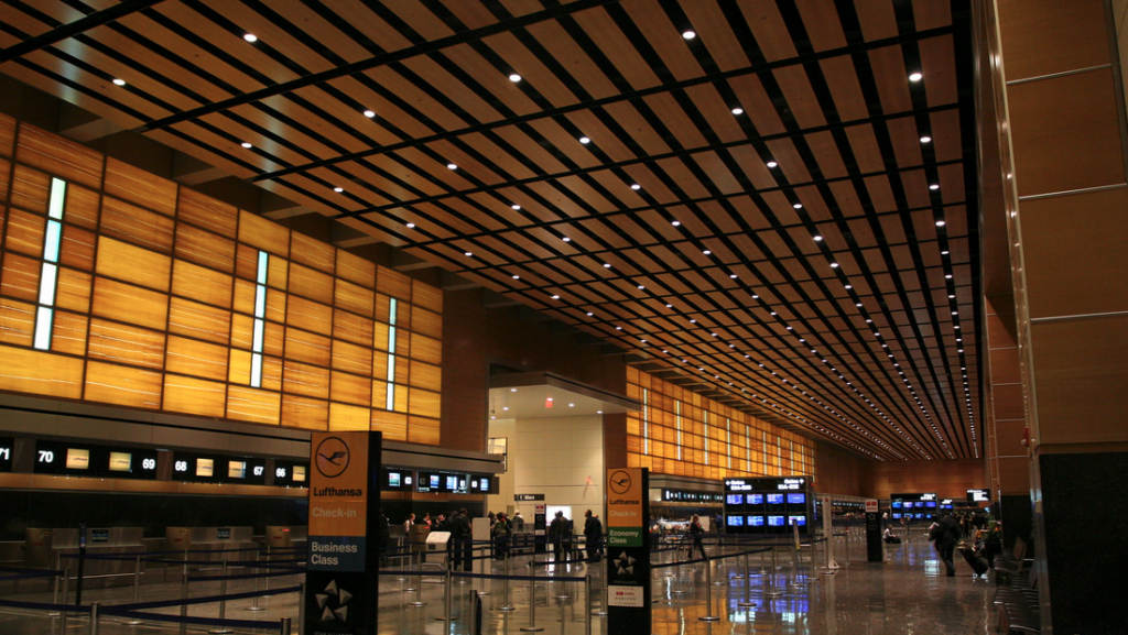 a large airport with people walking around