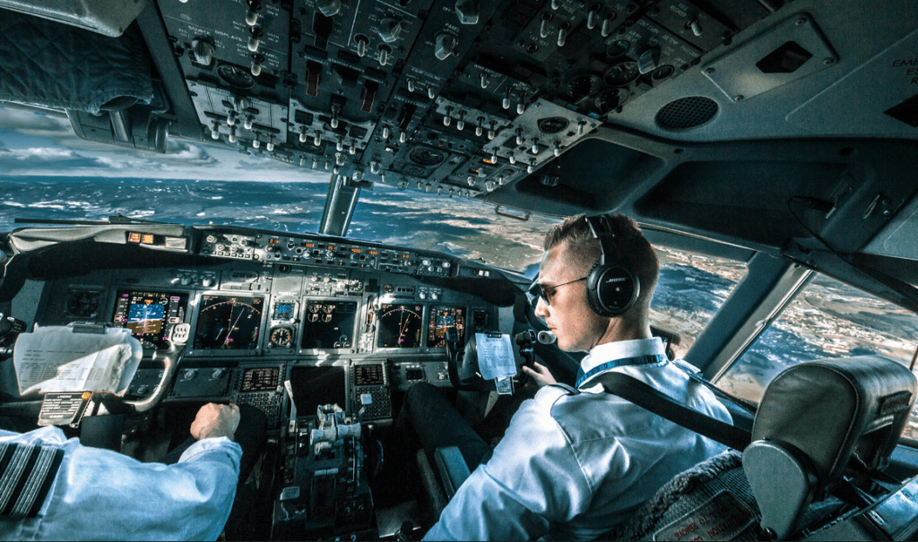 a man in a cockpit of an airplane