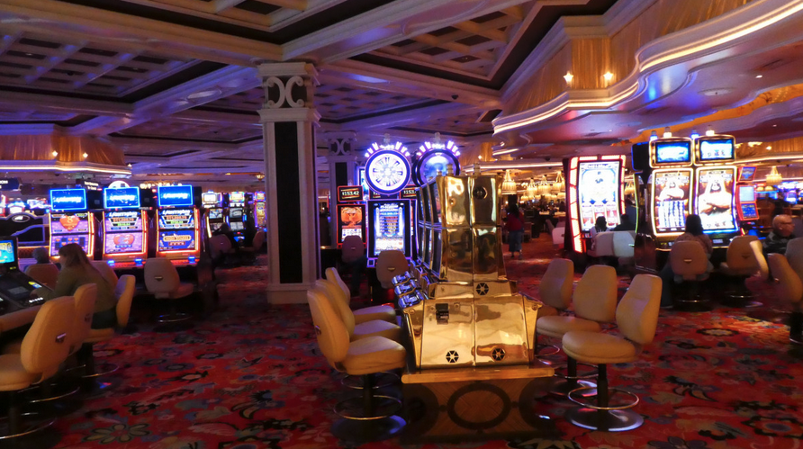 a room with a large slot machine and chairs