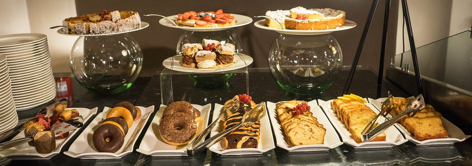 a table with plates of pastries and desserts