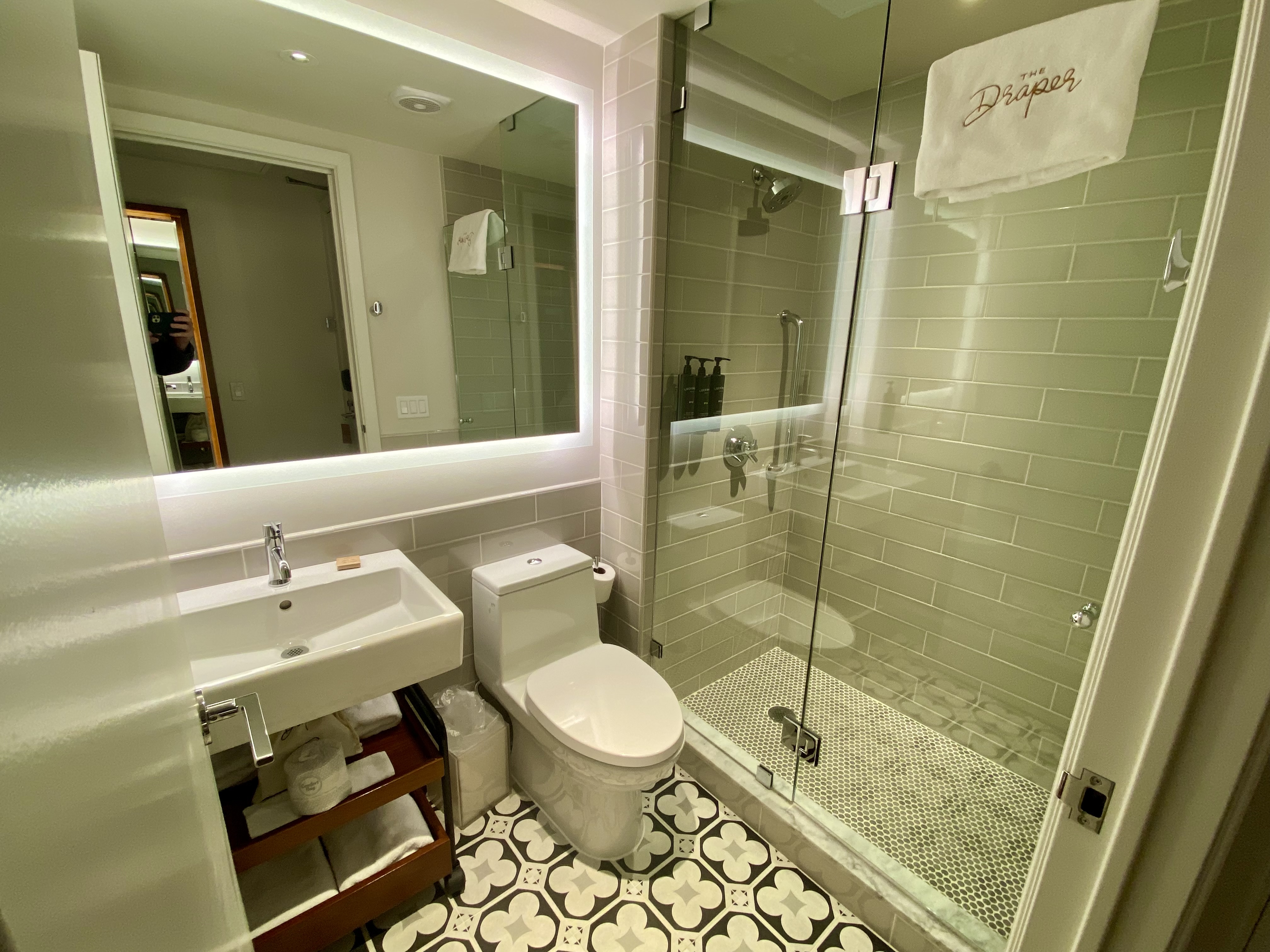 a bathroom with a glass shower and toilet