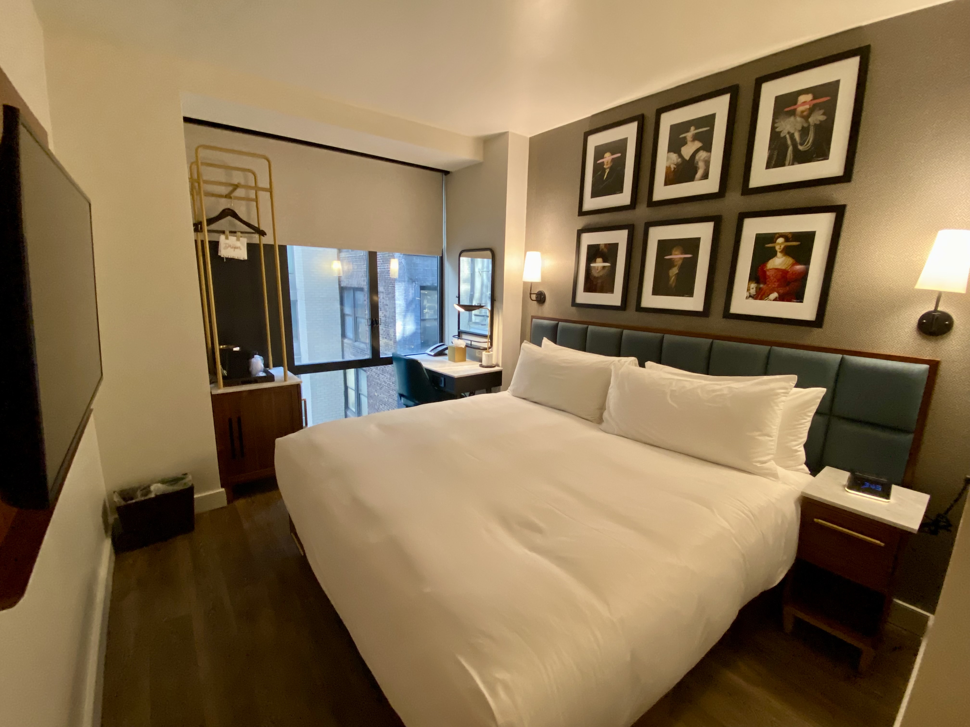 a bed with white sheets and pillows in a hotel room